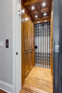 Another upgrade to the home is this beautiful Homelift elevator for access to all three levels.  Making access of all levels of this home easy, the elevator also was designed with custom detail that ensured the hardwood flooring matched the home.