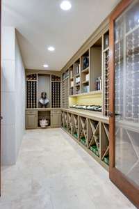 Behind the glass, double doors, find this wine room, offering custom-built shelving for a fabulous collection.