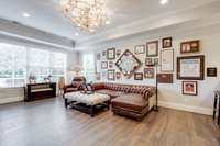 The tall ceilings add height and grandness to these luxury living spaces.  With the daylight and walk-out features, this basement recreation space is a sunny, elegant third level of this home.