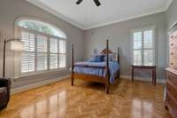 Large secondary bedroom with plantation style shutters..