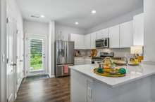 Stainless appliances sparkle in this beautiful kitchen.  Refrigerator to remain with the home.