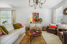 The living area is full of light and ample space.  Seller installed new chandelier in this room.