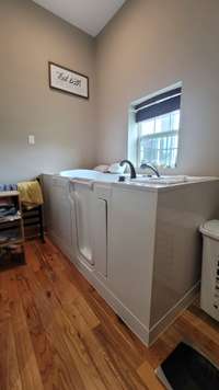 Professionally installed walk in bath tub in the primary bath. This bathroom also features a separate tile shower