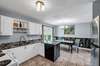 Kitchen is large enough for full size dining room table. Large window looks over generous yard