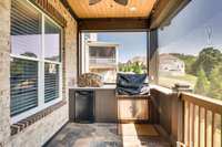 The owners added the built-in grilling area with a beverage refrigerator on the screened porch