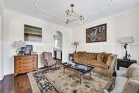 Hardwood floors & wainscoting in the formal dining room (furnished as a living room)