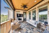 Wood ceiling, recessed lights, & ceiling fans on the screened porch