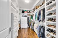 Primary walk-in closet with built-in shelving & 2 sets of drawers