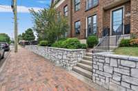 Landscaping is maintained by the HOA; the unit's front door is off the brick sidewalk just north of 5th & Monroe intersection.