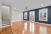 Living room area with bright windows and Juliet balcony.