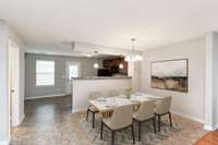 View looking into Dining Room and Kitchen. Virtually staged photo.