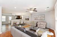 View of Living Room looking into Dining Room and Kitchen. Virtually staged photo.