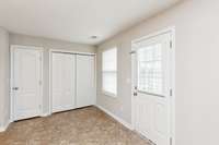 Extra space in Kitchen- Pantry door on the left, and washer/dryer closet on the right.