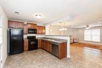 Kitchen view open to dining and living room.