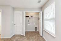 View inside the washer/dryer closet. Extra storage.