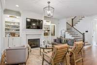 Living room offers built-ins (with lighted shelving and cabinet storage) surrounding fireplace and walks out to the private backyard oasis.