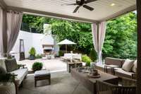 Backyard oasis features wonderful cabana porch, outdoor dining and wood burning fireplace (w/gas).