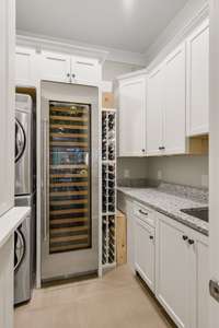 Laundry room/Pantry with wine fridge and storage.