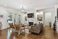 Living room offers built-ins (with lighted shelving and cabinet storage) surrounding fireplace and walks out to the private backyard oasis.