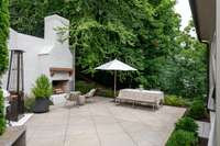 Backyard oasis features wonderful cabana porch, outdoor dining and wood burning fireplace (w/gas).