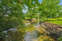 The creek running through the property is a peaceful delight, offering soothing sounds and picturesque views. 8699 Christiana Fosterville Rd   Christiana, TN  37037