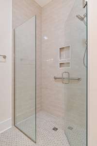 Zero-entry shower with handheld shower head and grab bar