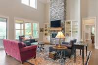 Custom built-in bookcases on either side of the stone gas fireplace, Large 96-inch ceiling fan