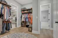 Primary bedroom closet leads to the laundry room