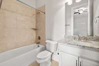 The private Bath features a storage vanity with granite counter top and tub/shower combo with tile surround.