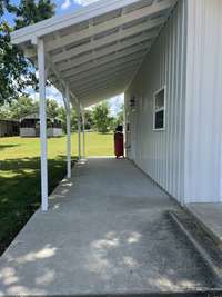 8x30 concrete covered lean to with air compressor.