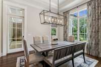 The breakfast room, located just off the kitchen, provides a cozy space that seamlessly opens to the covered, screened-in back porch—ideal for enjoying your morning coffee while taking in the serene surroundings.