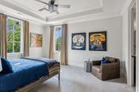 The elegant tray ceiling enhances the sophistication of this upstairs bedroom, while custom cabinetry and extensive tile work add both style and functionality.