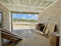 Covered back porch & patio on homesite large enough for a POOL!