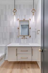 Elegant Formal Powder Bath with floating vanity and floor to ceiling wall splash