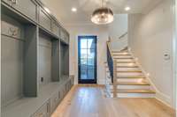 View of Rear Foyer/Mudroom with 3rd Powder Bath and rear staircase leads to private 6th Bedroom with ensuite Bath ideal for In-law suite or Home Office