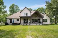 The covered back porch offers a beautiful private setting for relaxation.