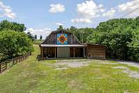 Beautiful barn with a sunflower painted by the owner. This huge barn allows for equipment storage, it is also an event center with a STAGE, and has a half bath, and a taxidermy room.