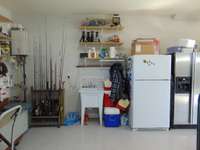 The garage is heated and cooled, top left is tankless Rinnai water heater, the 2 refrigerators have water hookups available to run ice makers, deep sink with hose bib.