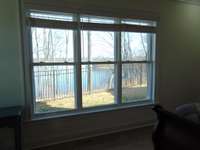 Lake view through primary bedroom window.