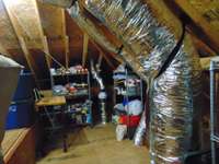 Radon vent fan in attic and more storage area.