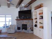 Fire place and built in book or display case in open living area.