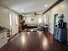 Looking from the kitchen back into the living room. Vaulted ceiling makes these room feel even larger.