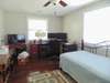 One of the other bedrooms with windows on two walls for wonderful light. This room is presently used as an office but still has room for  a day bed that makes into a king size bed.