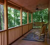 This home features two levels of covered decking with rocking chairs, a porch swing, and hot tub on the lower level!