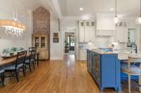 Kitchen Room with vaulted cathedral ceiling and brick focal wall