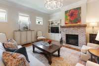 Brick gas fireplace with reclaimed wood mantle