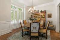 Formal dining room sits at the front of the home with surround sound and transom windows