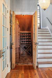 climate controlled wine room with reclaimed antique doors and hardware