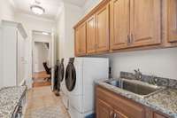 When you come in the friend's entrance, you enter the mudroom/laundry room featuring a large basin sink and plenty of cabinets