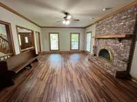 Extra large living room with wood burning fireplace. New LVP Flooring.